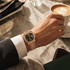 Rolex Day-Date 40 Rose Gold Olive - Wrist shot, cafe lifestyle