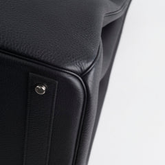 Close-up of a black leather product with a metallic accent 